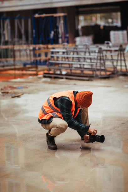 photographer on the construction site photographs the works